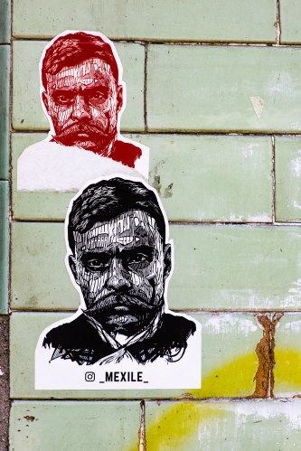 Mexico city posters two portraits on green tile wall-1